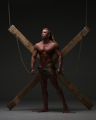 Wall Mural - Sexual naked man, muscular, hands tied rope to wooden beams