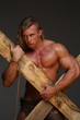 © kazanovskyiphoto - Men with perfect muscular naked torso, holding hands wooden beams