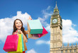 young happy woman with shopping bags over big ben