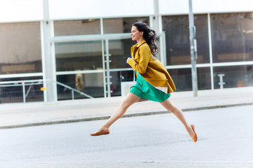 Canvas Print - happy young woman or teenage girl on city street