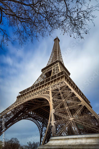 Low angle view Eiffel Tower and passing clouds, Paris, France Poster