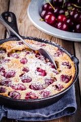 Wall Mural - Clafoutis cherry pie on  wooden background