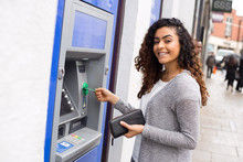 Young Woman At The Cash Machine