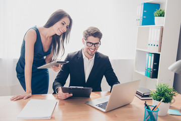 Young man and woman working together at financial project