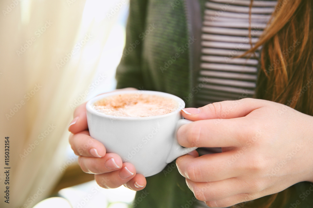 Woman hands holding cup of coffee