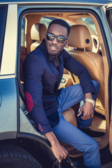 Wall Mural - African american male posing in a car.