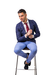 Wall Mural - Young man in blue business jacket and jeans isolated