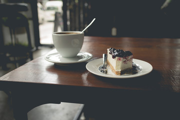 Hot cappuccino coffee that serve with blueberry cake