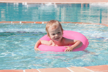 Little boy playing in the pool