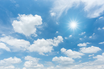 Wall Mural - blue sky with clouds and sun reflection. looking up view