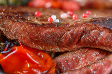 a piece of medium rare beef with pieces cut and close-up. European cuisine