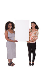 2 young women holding a poster board isolated on white