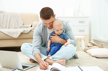 Wall Mural - Father holding sweet baby and working