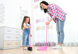 © Africa Studio - Daughter and mother sweeping together in room