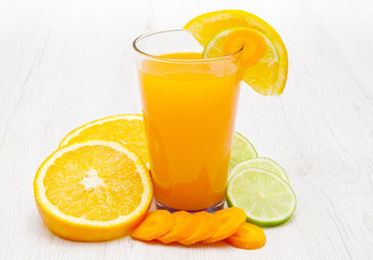 Glasses of ace  juice with carrot,orange and lemon