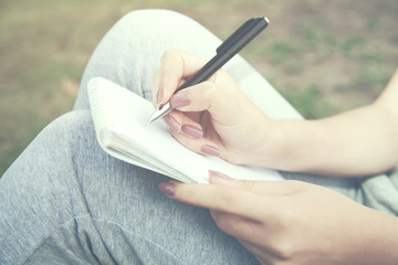 Wall Mural - woman hand notebook on nature