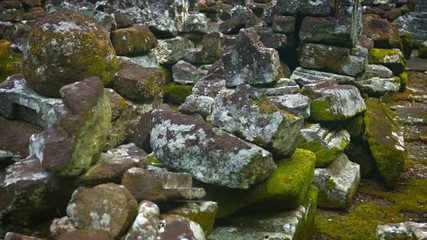 Wall Mural - Panning shot of a pile of ancient, hand cut stones from a Hindu temple ruin in Southeast Asia. Video 3840x2160