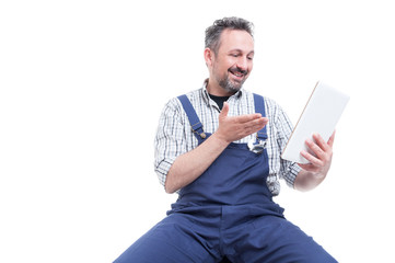 Wall Mural - Happy handyman wathcing something funny on tablet