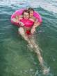 © travelview - brothers in a swim ring have fun in the ocean
