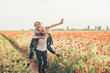 © kurapatka - young happy couple having fun in poppy field
