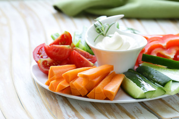 Wall Mural - fresh vegetables snack - carrots, sweet pepper, cucumbers and tomatoes with dip