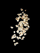 Popcorn Bursting In The Air Over Black Background