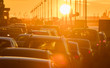 Cars are in traffic jam during a beautiful golden sunset.