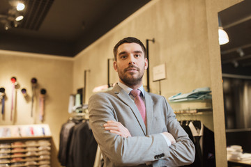Wall Mural - young man or businessman in suit at clothing store