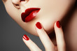 © looking2thesky - Beauty fashion model face. Manicured hand with red nails. Red lips and nails. Beautiful woman with luxury make-up and perfect manicure. Make-up concept