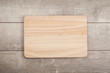 Wooden cutting board on old wooden table.Top view.