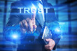 © WrightStudio - Businessman is pressing on virtual screen and slelecting Trust.