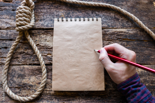 Fotografie, Tablou man writes a suicide note in the notebook