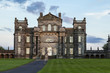 Seaton Delaval Hall, Northumberland, England, UK, bathed in evening sunlight. with dramatic clouds overhead.