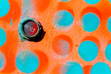 Red Reset Button On Wall Painted With Blue And Orange Dots