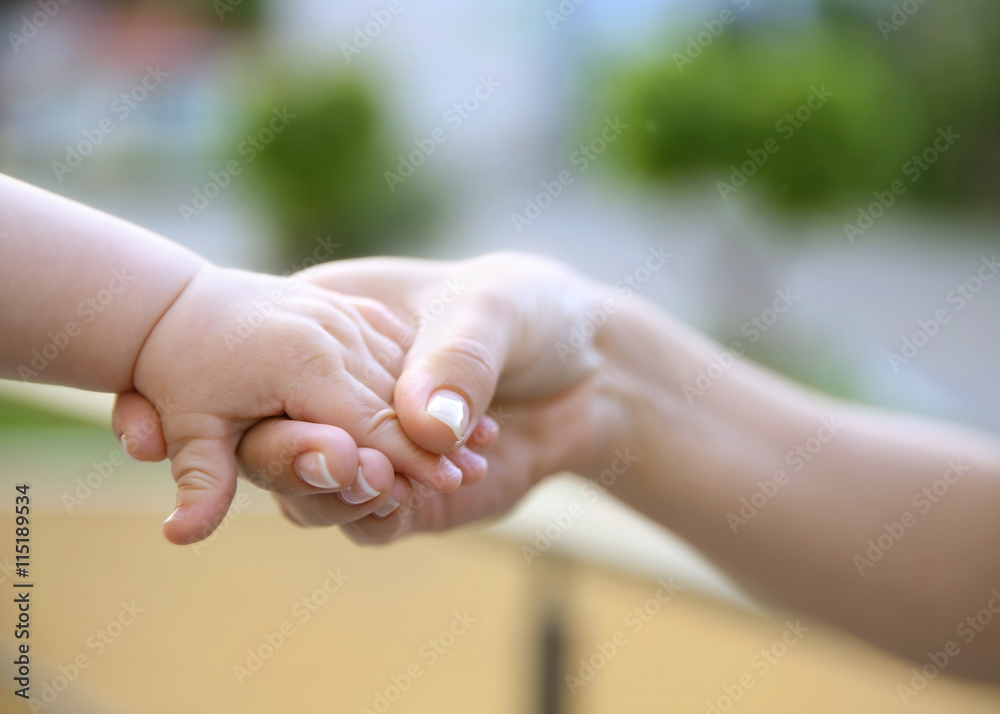 Child holding mother hand