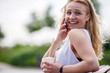 © snedorez - Cute blonde woman outdoors talking on phone and laughing