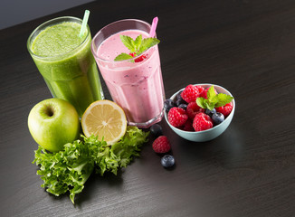 Glasses of fresh cold smoothie with fresh fruit and spinach and fresh beries