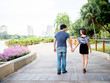 © twinsterphoto - Asian couple holding hands walking in the park