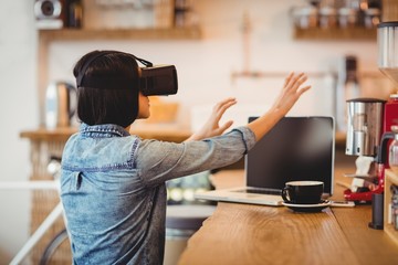 Poster - Young woman using the virtual reality headset