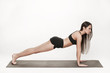 © denisovdmitry - Woman exercising on mat
