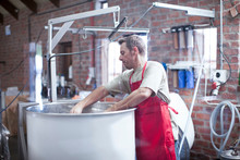 Man In Microbrewery Checking Fermentation Tank