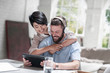 © Connect Images - Loving couple using digital tablet