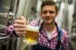 © WavebreakmediaMicro - Brewer holding a glass of pint beer