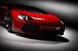 © Photocreo Bednarek - Red fast sports car in spotlight, black background. Shiny, new, luxurious.
