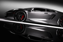 Grey Fast Sports Car In Spotlight, Black Background. Shiny, New, Luxurious.