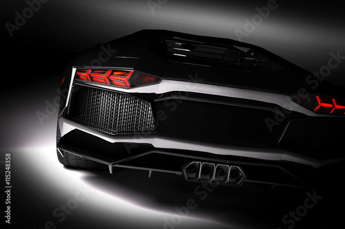 Obraz na plátne Black fast sports car in spotlight, black background