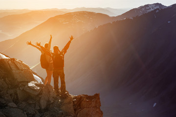 Happy couple winner mountain top concept