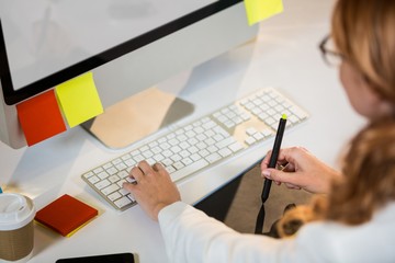 Poster - Businesswoman working with graphics tablet at desk