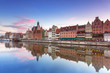Old town of Gdank with reflection in Motlawa river at sunset, Poland
