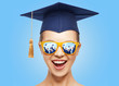 © Syda Productions - happy teenage girl in shades and mortarboard hat